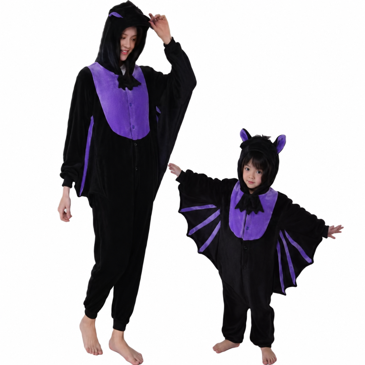 Adult and child wearing black and purple bat kigurumi onesies